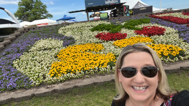 Woman In Front of Flowers